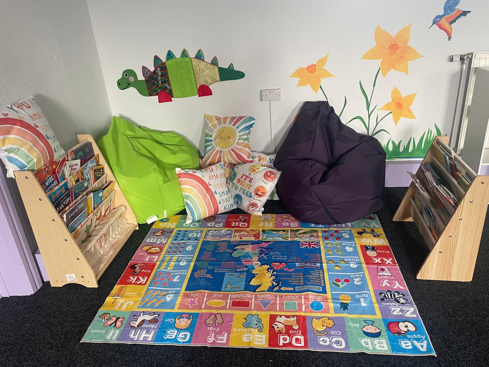 Ysgol Bethania reading corner with books, colourful cushions and learning displays