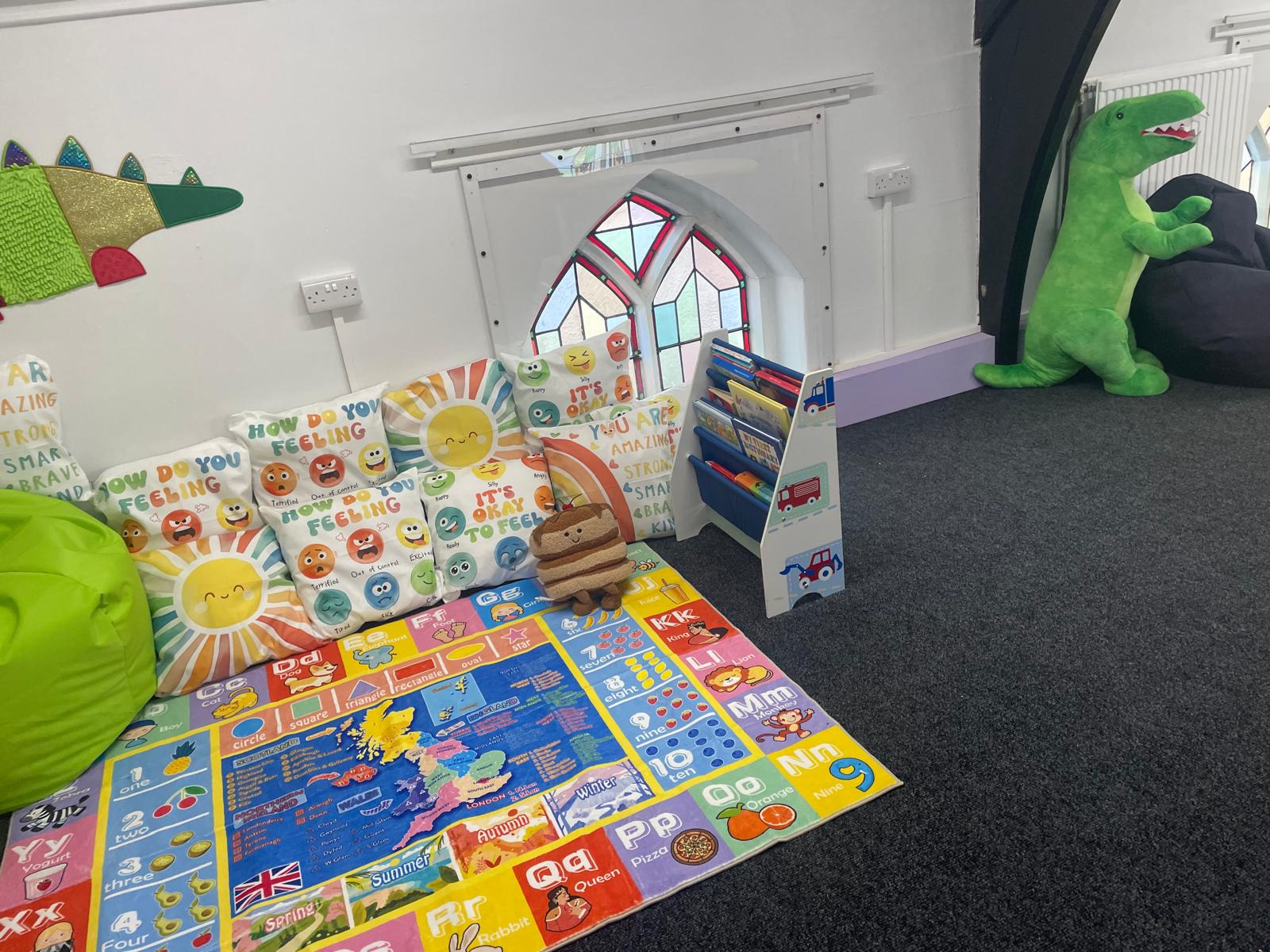 Feelings cushions and books in a welcoming wellbeing corner